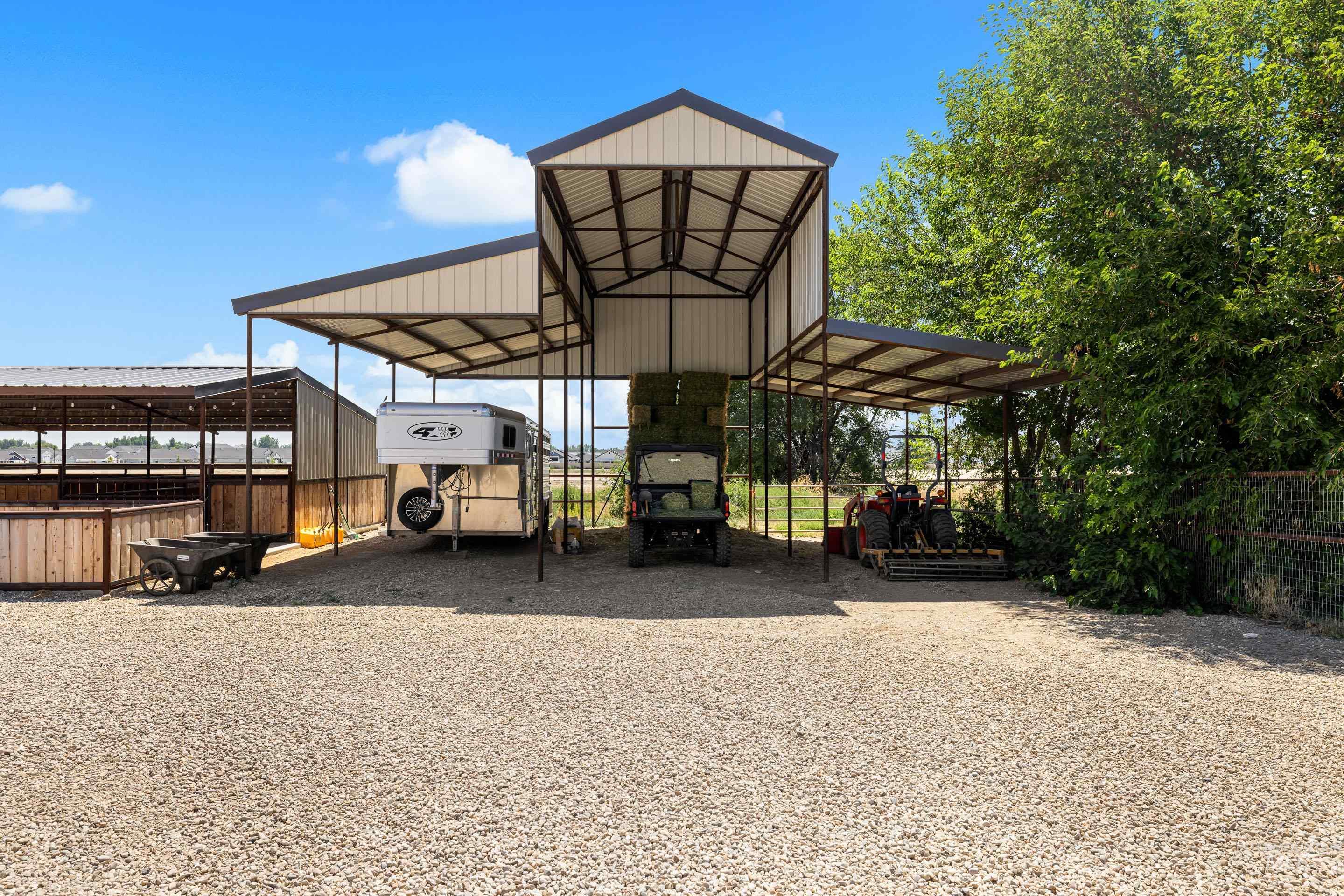 9819 Foothill Road Middleton, ID 83644 - Photo 49 of 50 View of parking / parking lot featuring a carport and gravel driveway