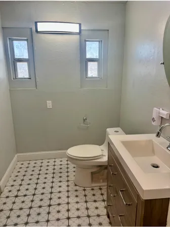 a bathroom with a sink toilet and vanity
