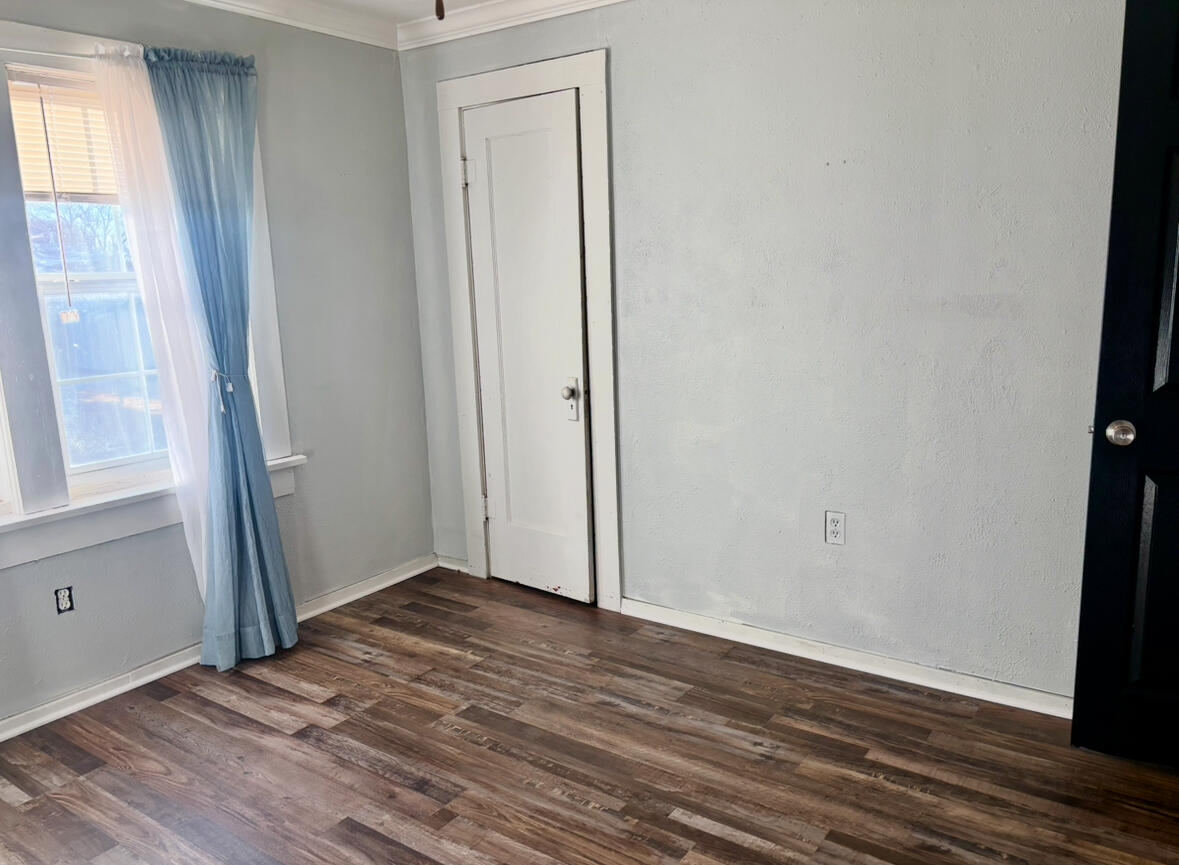 2224 36th Street Lubbock, TX 79412 - Photo 21 of 33 an empty room with wooden floor and windows