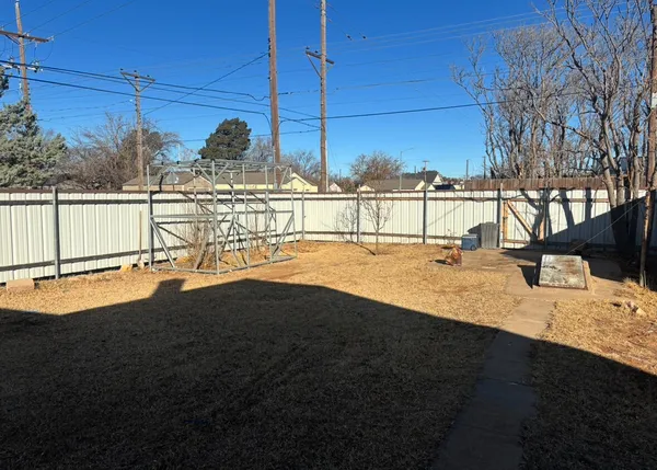 a view of a swimming pool with a yard
