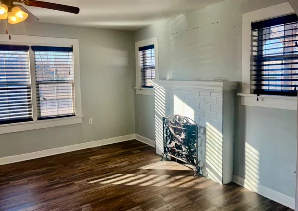 a view of a livingroom with wooden floor and a window