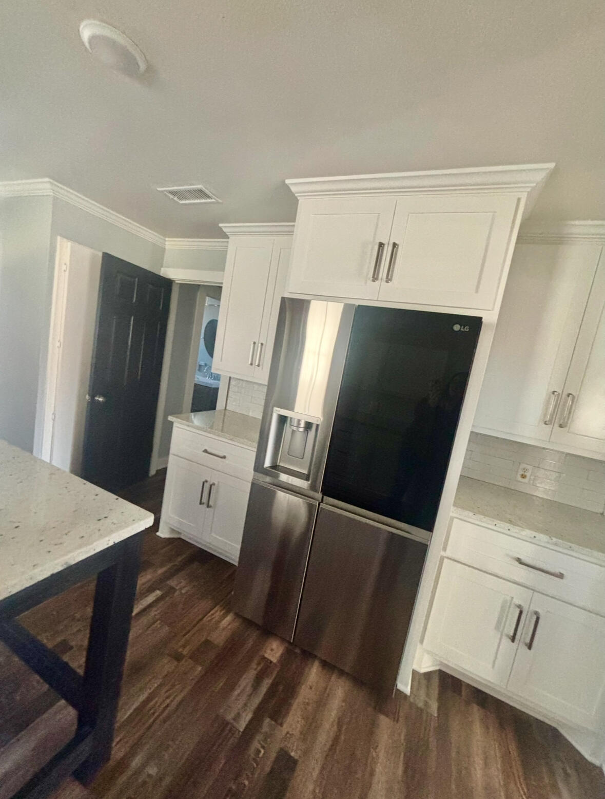 2224 36th Street Lubbock, TX 79412 - Photo 9 of 33 a view of a refrigerator in kitchen and wooden floor