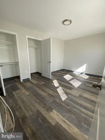 a view of an empty room and wooden floor