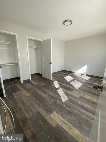 a view of an empty room and wooden floor