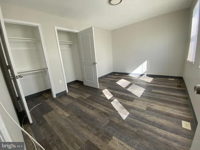 a view of an empty room and wooden floor