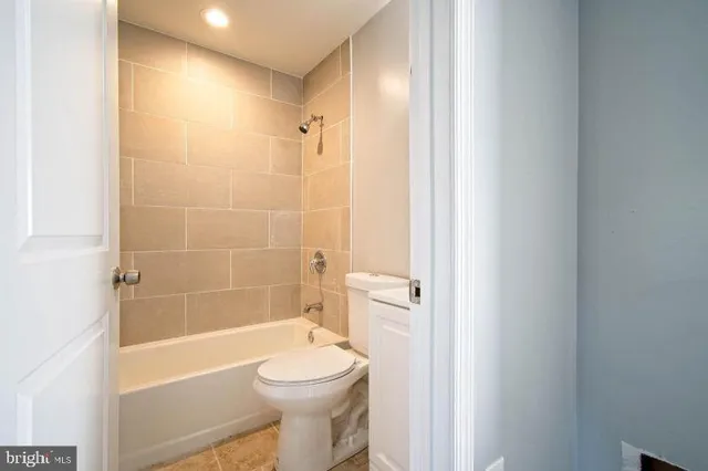 a bathroom with a toilet and a bathtub