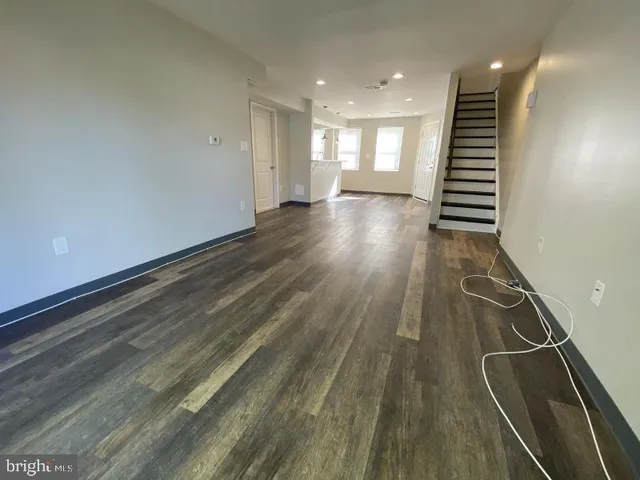 a view of a room with wooden floor and stairs
