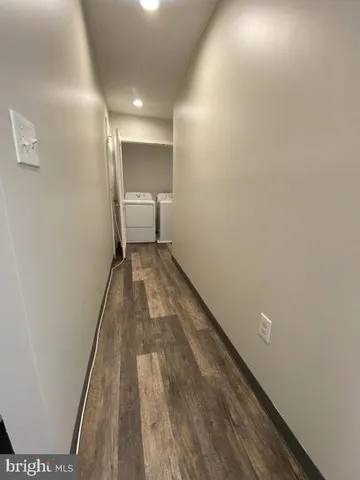 a view of a room with wooden floor