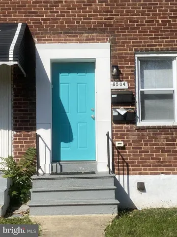 a view of front door of house with stairs
