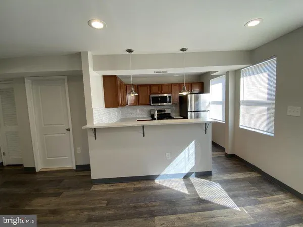 a living room with kitchen island furniture and a window
