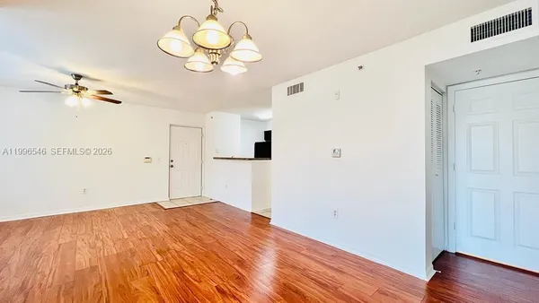 a view of a bedroom with wooden floor
