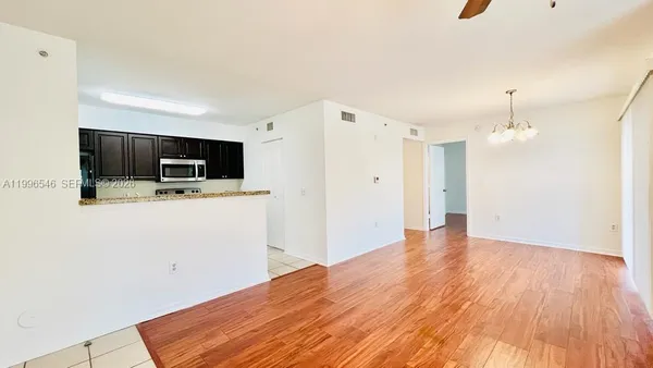a view of a kitchen with a flat screen tv and refrigerator