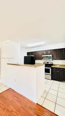 a kitchen with a stove and a refrigerator