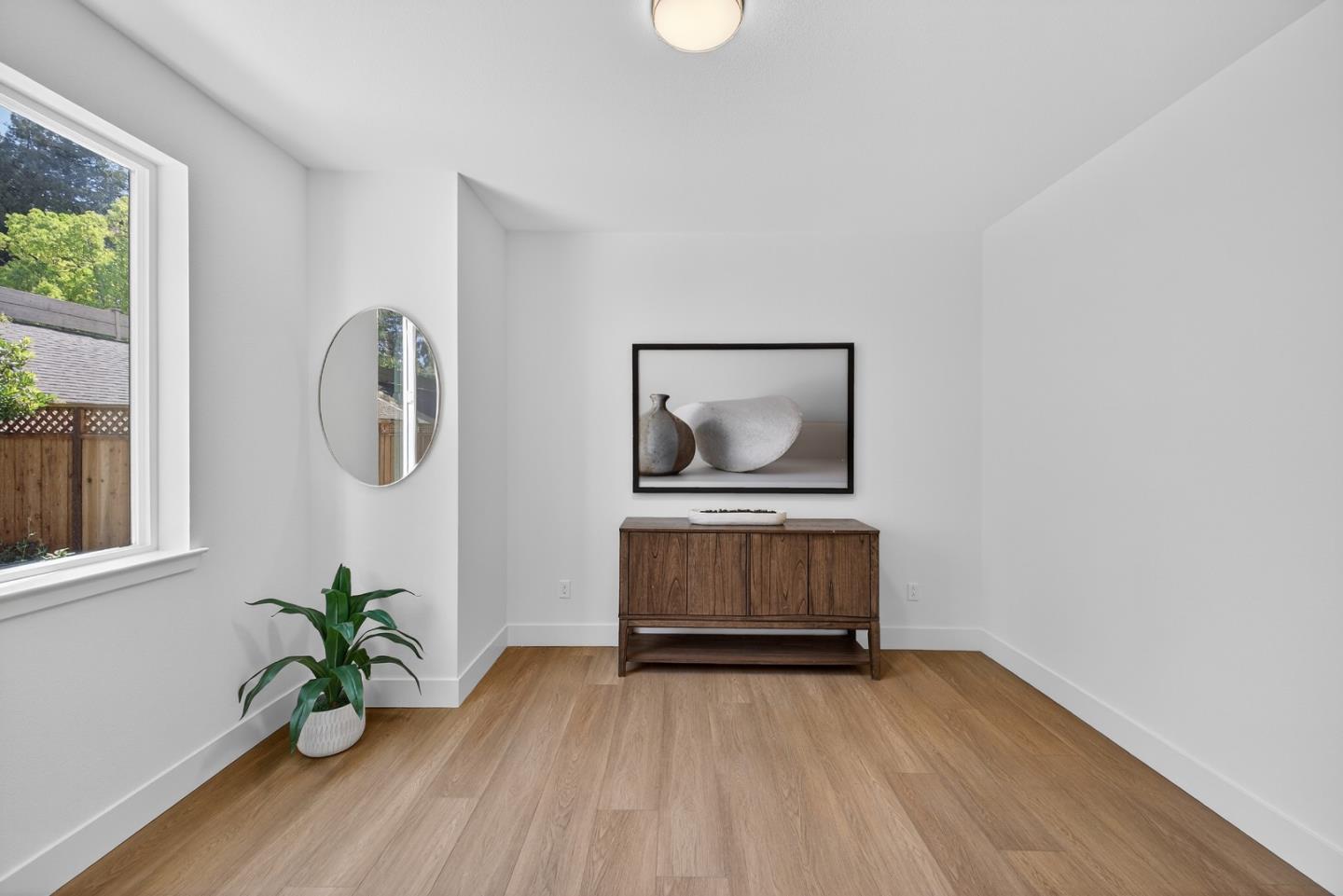 955 Woodside Road Redwood City, CA 94061 - Photo 6 of 46 a view of a hallway with wooden floor and a potted plant
