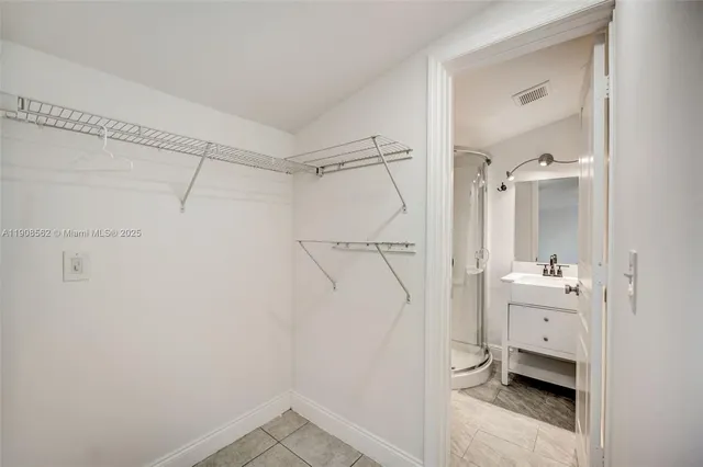 a bathroom with a sink a mirror and a shower
