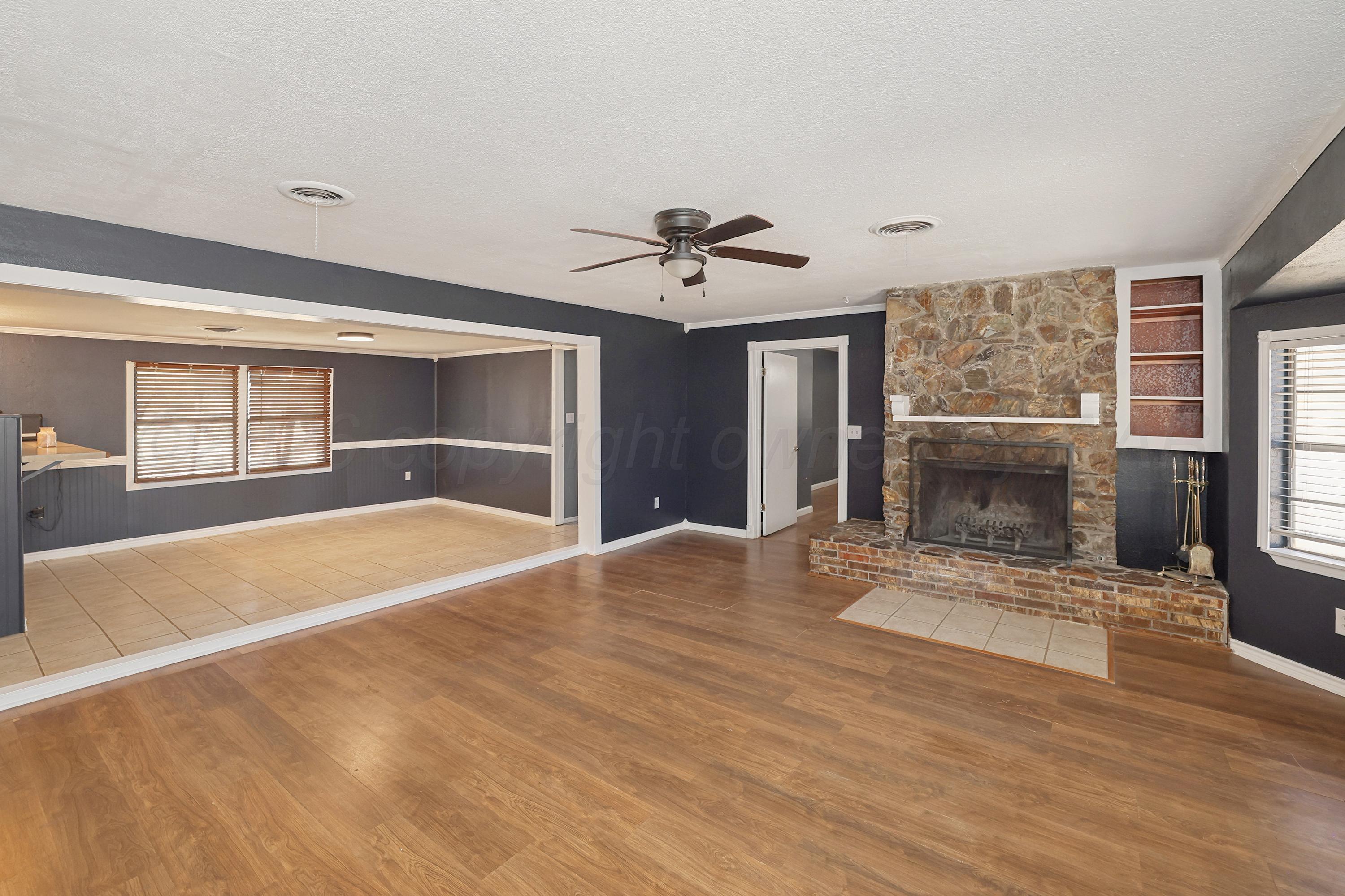 14200 Savannah Road Amarillo, TX 79118 - Photo 2 of 34 a view of an empty room with a fireplace and a window