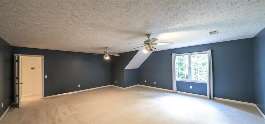 6945 John Rivers Road Fairburn, GA 30213 - Photo 14 of 65 a view of an empty room with a window