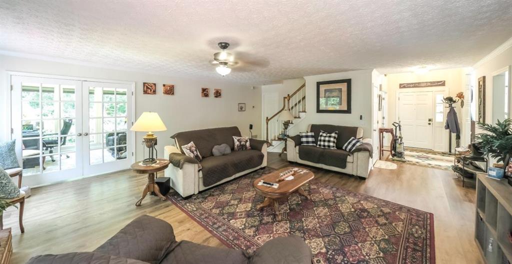 6945 John Rivers Road Fairburn, GA 30213 - Photo 16 of 65 a living room with furniture and a large window