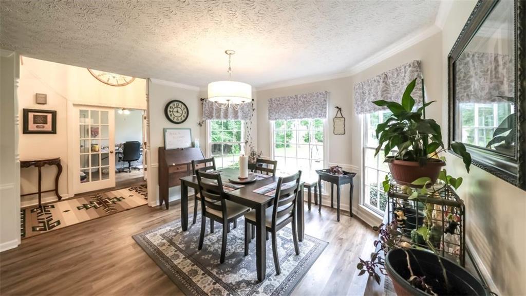 6945 John Rivers Road Fairburn, GA 30213 - Photo 17 of 65 a view of a dining room with furniture window and wooden floor