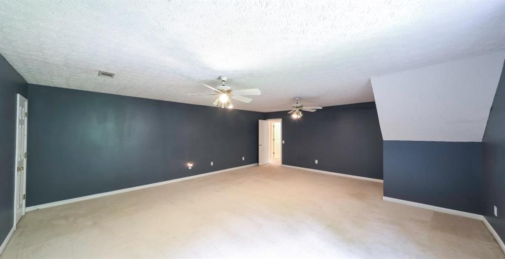 6945 John Rivers Road Fairburn, GA 30213 - Photo 18 of 65 a view of an empty room with a chandelier fan