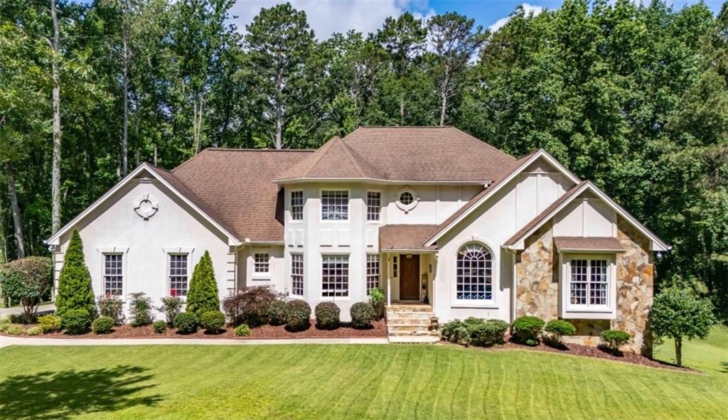 6945 John Rivers Road Fairburn, GA 30213 - Photo 2 of 65 a view of house with garden