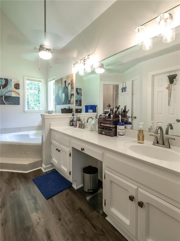 6945 John Rivers Road Fairburn, GA 30213 - Photo 22 of 65 a spacious bathroom with double vanity and a mirror