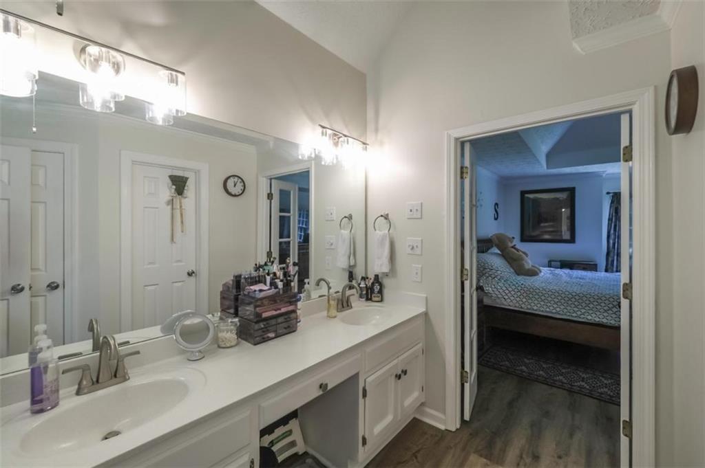 6945 John Rivers Road Fairburn, GA 30213 - Photo 23 of 65 a en suite bathroom with a double vanity sink and mirror