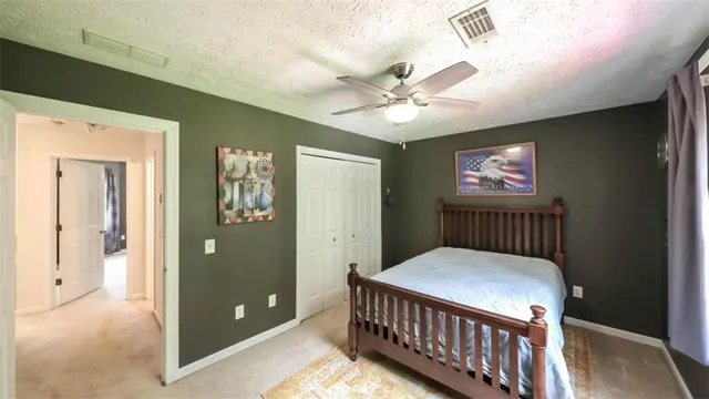 a bedroom with a bed and a dresser in it