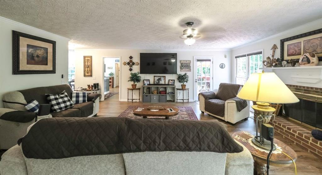 6945 John Rivers Road Fairburn, GA 30213 - Photo 25 of 65 a living room with furniture and a flat screen tv