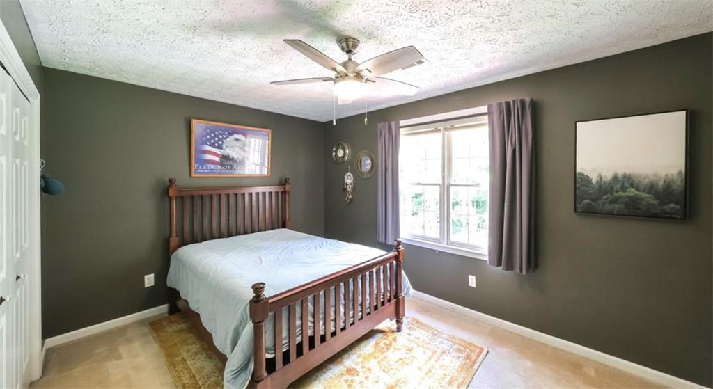 6945 John Rivers Road Fairburn, GA 30213 - Photo 26 of 65 a bedroom with bed and a window