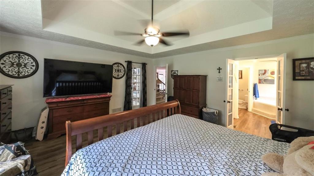 6945 John Rivers Road Fairburn, GA 30213 - Photo 28 of 65 a bedroom with a bed and a television