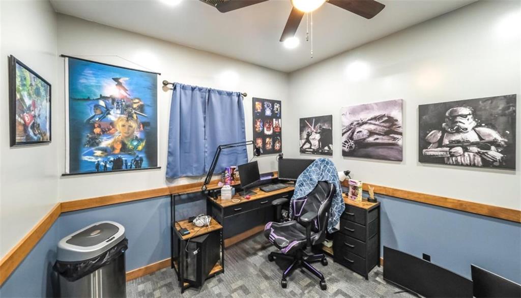 6945 John Rivers Road Fairburn, GA 30213 - Photo 29 of 65 a view of a workspace with furniture and a ceiling fan