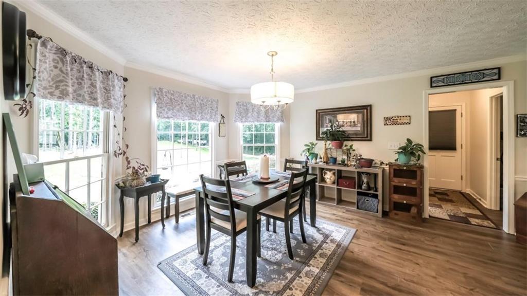 6945 John Rivers Road Fairburn, GA 30213 - Photo 31 of 65 a view of a a dining room with furniture window and wooden floor