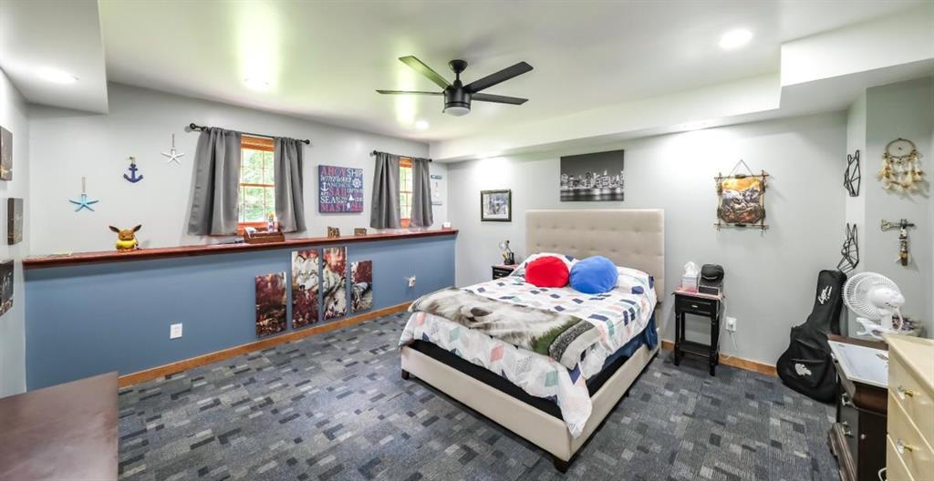 6945 John Rivers Road Fairburn, GA 30213 - Photo 32 of 65 a bedroom with a bed and a dresser in it