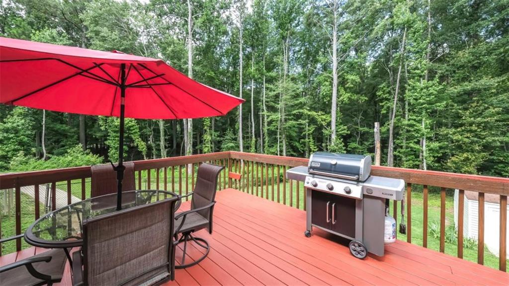 6945 John Rivers Road Fairburn, GA 30213 - Photo 33 of 65 a view of a deck with furniture and barbeque grill