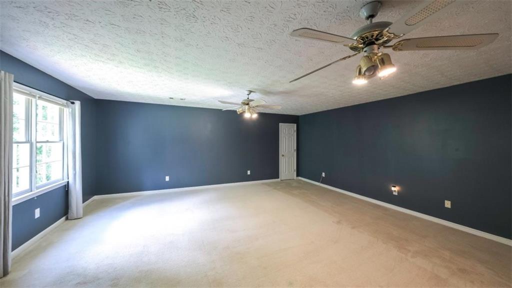 6945 John Rivers Road Fairburn, GA 30213 - Photo 34 of 65 a view of an empty room with a window
