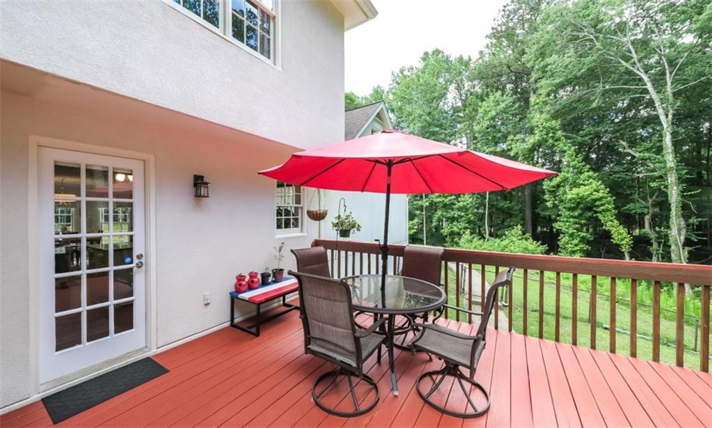 6945 John Rivers Road Fairburn, GA 30213 - Photo 37 of 65 a view of balcony with wooden floor and umbrella