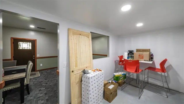 a living room with furniture wooden floor and a large window
