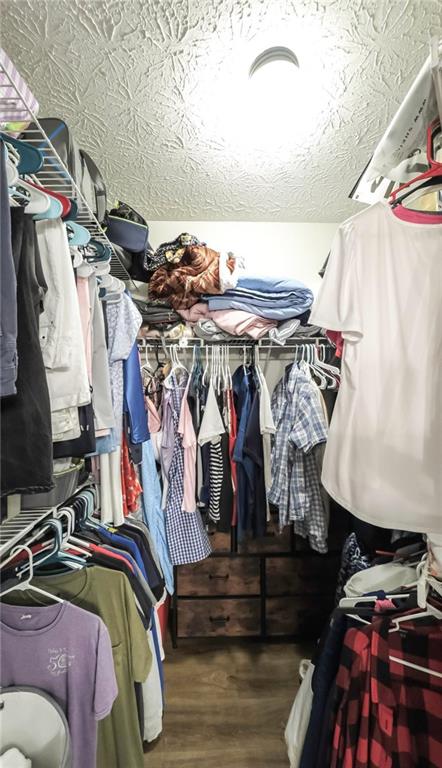6945 John Rivers Road Fairburn, GA 30213 - Photo 47 of 65 a view of walk in closet with clothes and shoes
