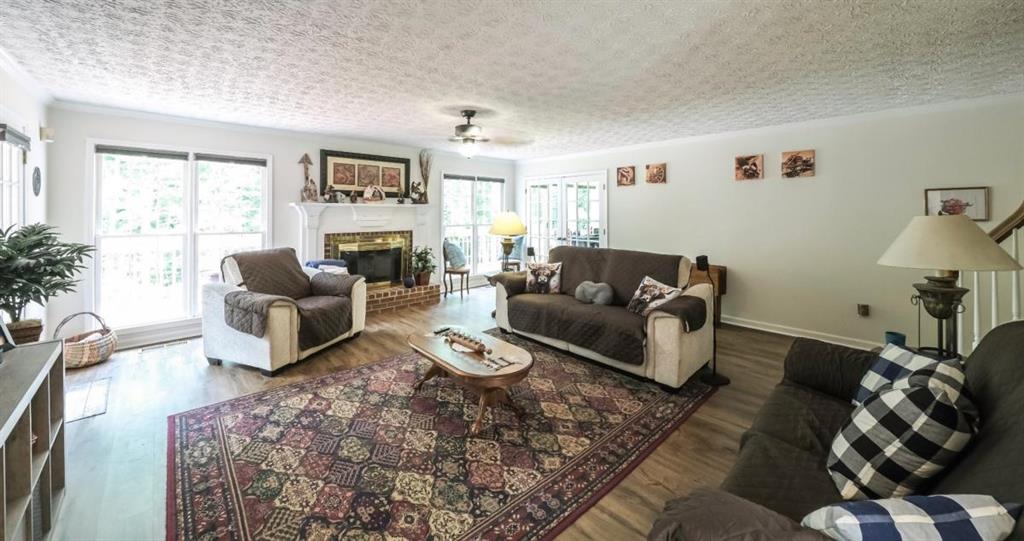 6945 John Rivers Road Fairburn, GA 30213 - Photo 53 of 65 a living room with furniture wooden floor and a large window