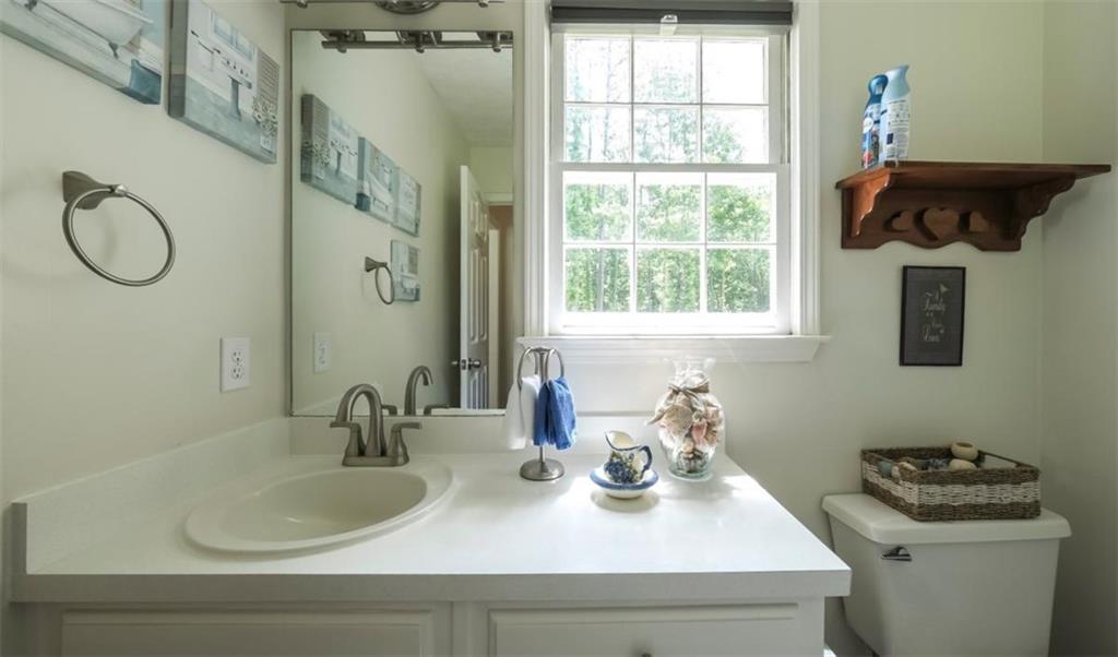 6945 John Rivers Road Fairburn, GA 30213 - Photo 54 of 65 a bathroom with a sink and a mirror