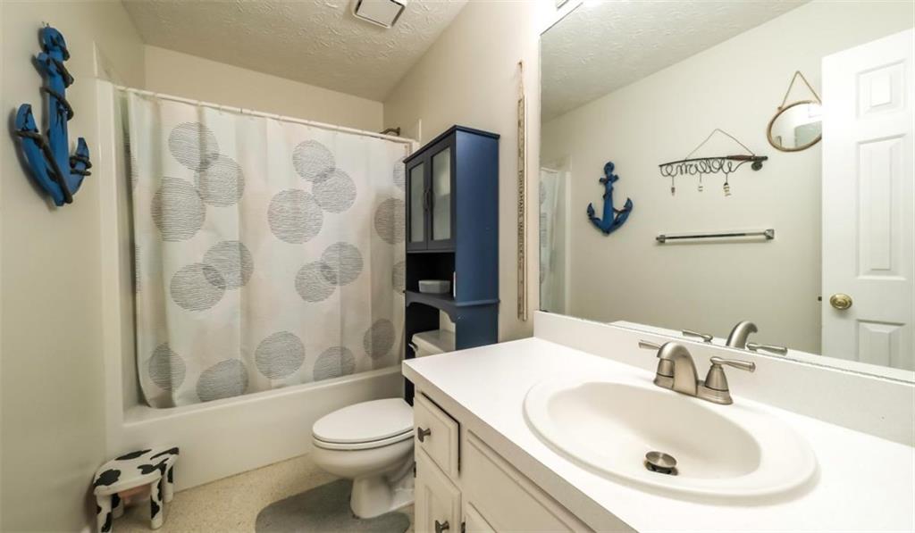6945 John Rivers Road Fairburn, GA 30213 - Photo 56 of 65 a bathroom with a sink and a mirror