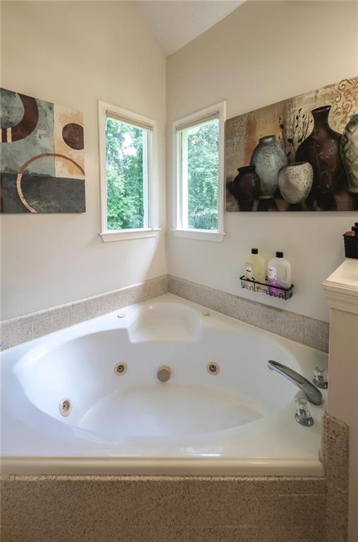 6945 John Rivers Road Fairburn, GA 30213 - Photo 60 of 65 a bath tub sitting next to a window