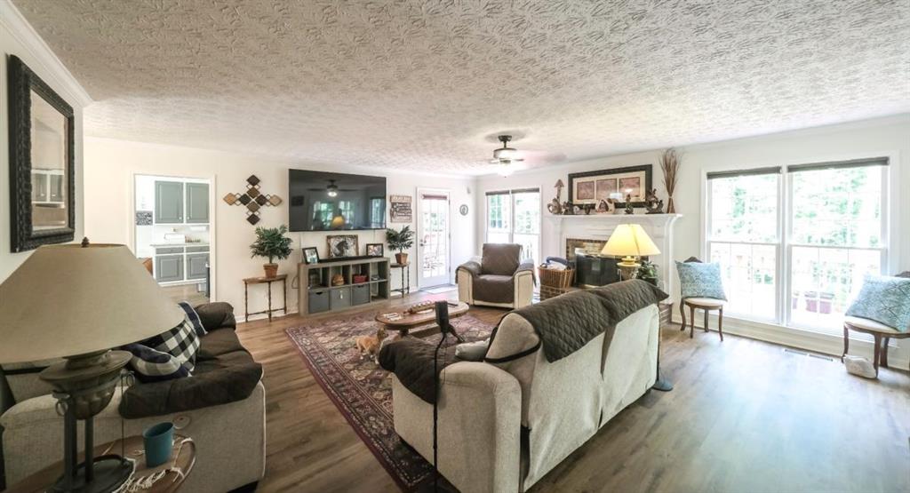 6945 John Rivers Road Fairburn, GA 30213 - Photo 63 of 65 a living room with furniture and a flat screen tv