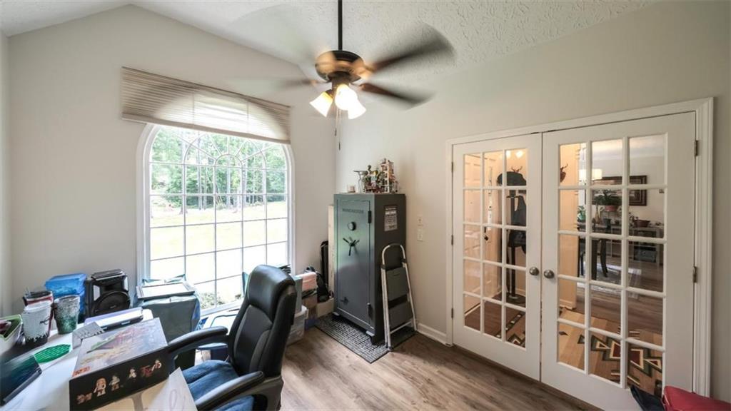 6945 John Rivers Road Fairburn, GA 30213 - Photo 64 of 65 a view of a workspace with furniture and a window