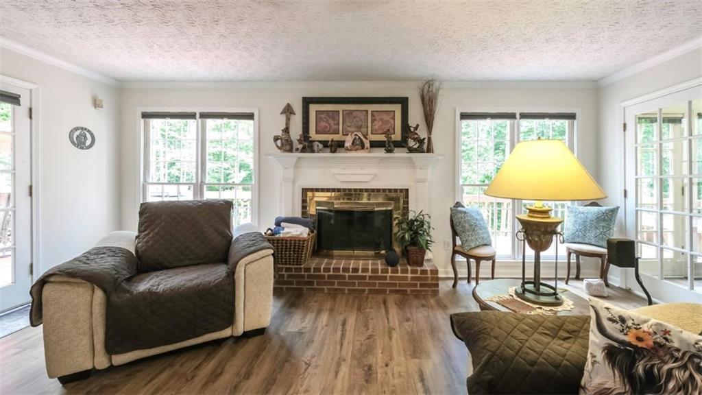 6945 John Rivers Road Fairburn, GA 30213 - Photo 65 of 65 a living room with furniture a window and a fireplace