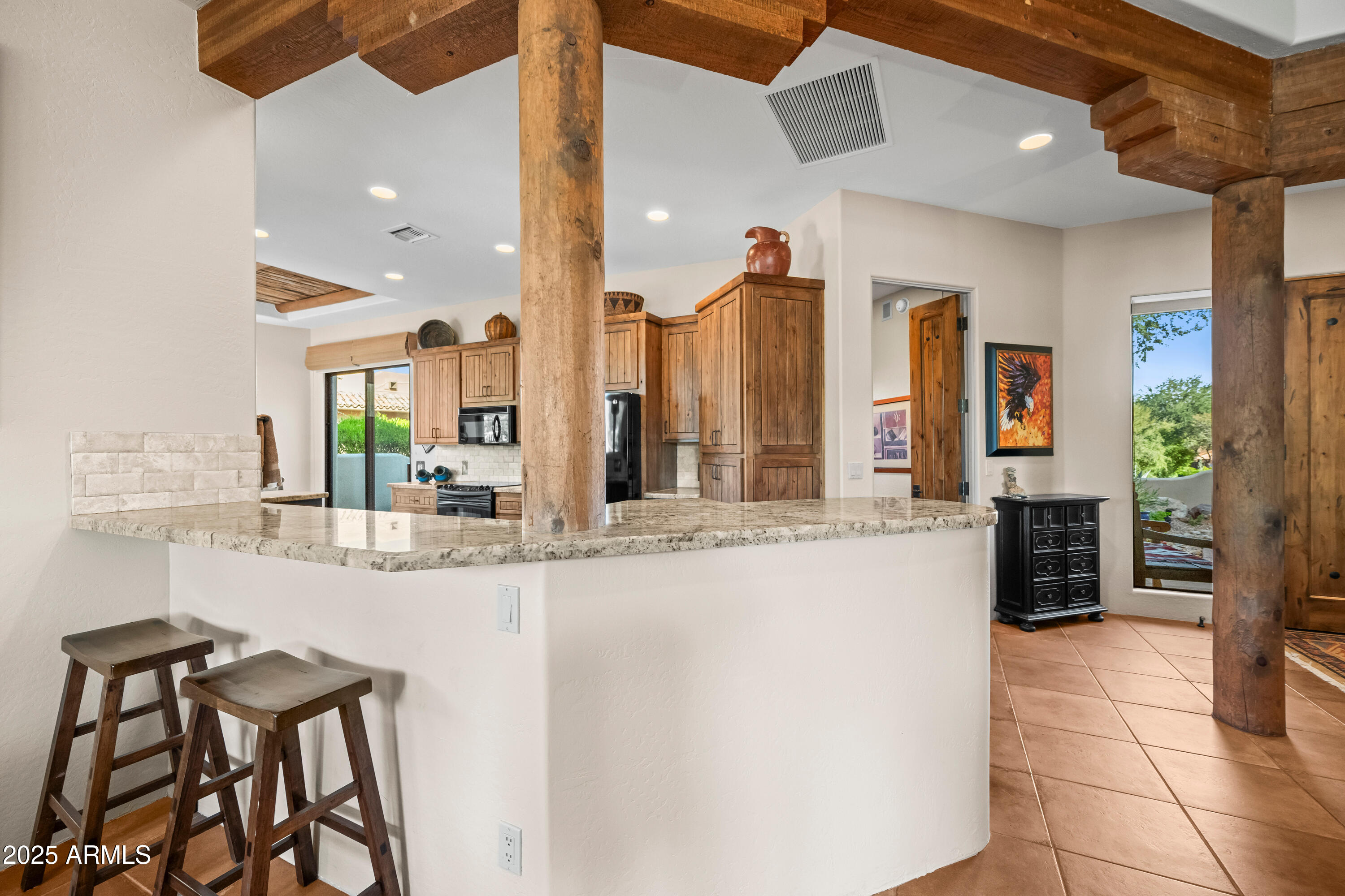 26708 North Aguila Road Rio Verde, AZ 85263 - Photo 12 of 46 a large kitchen with kitchen island granite countertop a counter space a sink and cabinets