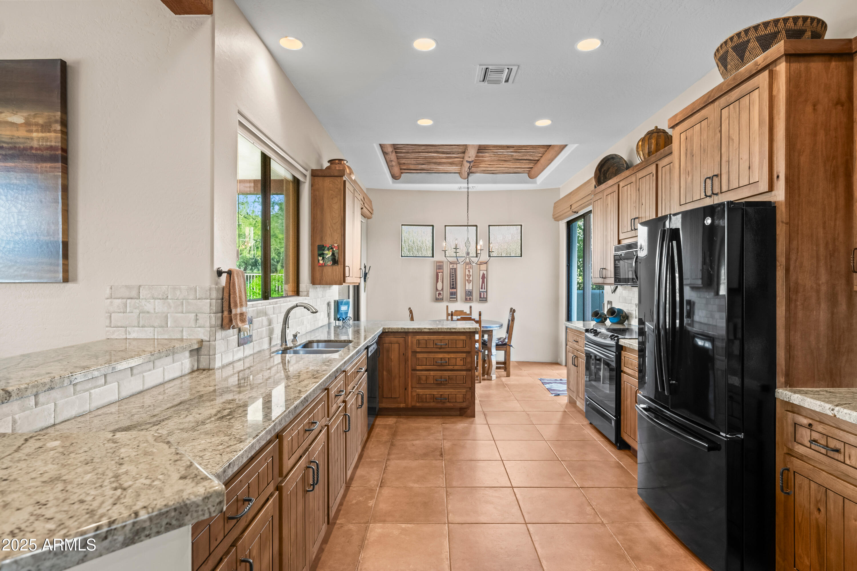 26708 North Aguila Road Rio Verde, AZ 85263 - Photo 13 of 46 a kitchen with stainless steel appliances granite countertop a refrigerator and a sink