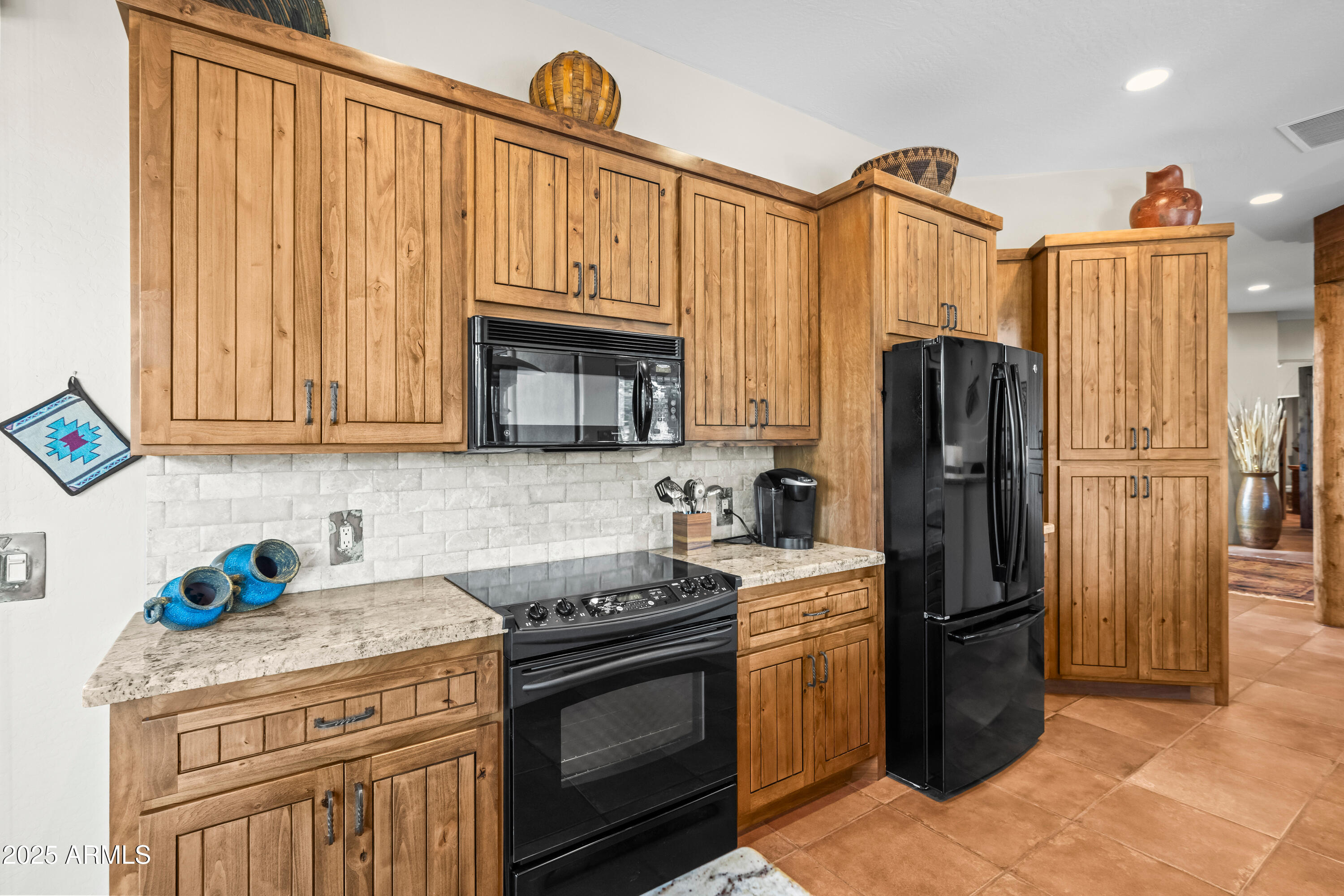 26708 North Aguila Road Rio Verde, AZ 85263 - Photo 14 of 46 a kitchen with stainless steel appliances granite countertop a refrigerator a stove and a sink