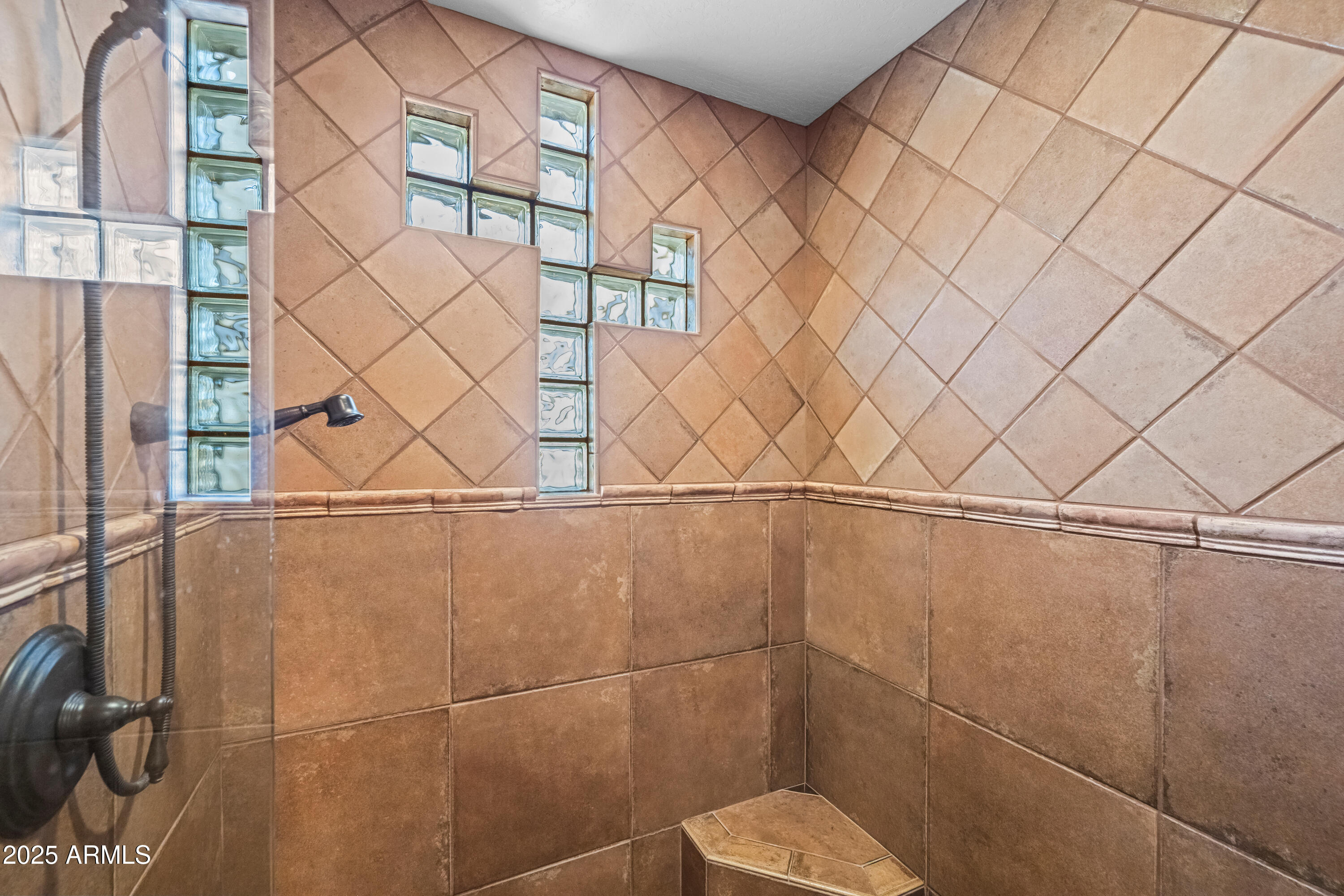 26708 North Aguila Road Rio Verde, AZ 85263 - Photo 19 of 46 a bathroom with a toilet and a shower curtain